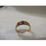 18ct gold ring set with three rubies, the largest 4mm x 3.5mm approx, British assay marks, 4g