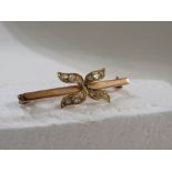 9ct gold bar brooch with a bow-shape setting of twelve diamonds, British assay marks, length 3.