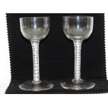 A pair of early 19th century wine glasses with white multi helix glass stems with a tiny oval bubble