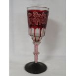 An overlaid ruby glass goblet with berries and leaves and slice cut to the shoulder. A spiral
