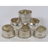 Six assorted silver napkin rings of various assay and makers (three monogrammed, a pair faceted, and