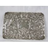 Oblong silver tray with repousse scrolled foliage, mask heads and birds, the central reserve