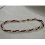 A jasper, onyx and cultured pearl triple-strand necklace with yellow metal clasp stamped 14KT, and