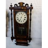 An eight day chiming late Victorian wall clock with a parquetry framed door and a rosewood case. The