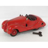 Schuco Examico 4001 tin plate clockwork model of a red 1930s BMW (key in office)