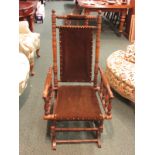An American rocking chair with spindle turned mahogany framed, brown velvet seat back and neck