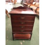 Edwardian four drawer music cabinet with moulded copper handles, galleried top and under tier (