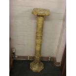 A stone plant pedestal resembling marble with a gun barrel column and octagonal base (height 98cm)