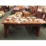 Mid 20th century large and plain desk in a pale redwood with three recessed drawers to one side,