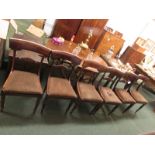 Six early Victorian mahogany dining chairs with carved stylistic eagle to the central back bar, drop