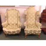 Two 1920's wingback armchairs upholstered in spotted lime green chintz, with walnut cabriole feet