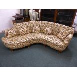An early 20th century curved button back sofa with cabriole legs and scallop shell to the