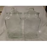 Pair of Scarborough and Company clear glass sweet jars, square section with round necks and lids,