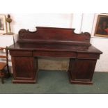 A very large and plain Victorian mahogany veneered serving sideboard raised on pedestal cupboards,