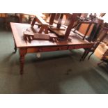 A large mahogany writing table with a deteriorated red leather scriber, two drawers and two faux
