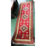 HAND KNOTTED INDIAN KAZAK STYLE FLOOR RUG, RED GROUND WITH TASSELLED EDGE