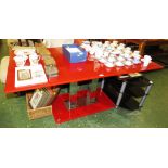 RECTANGULAR RED GLASS DINING TABLE RAISED ON TWO CHROMIUM SQUARE COLUMNS ON GLASS BASE