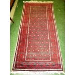 DARK RED GROUND FIVE MARGIN RUG WITH HEXAGONAL MEDALLIONS