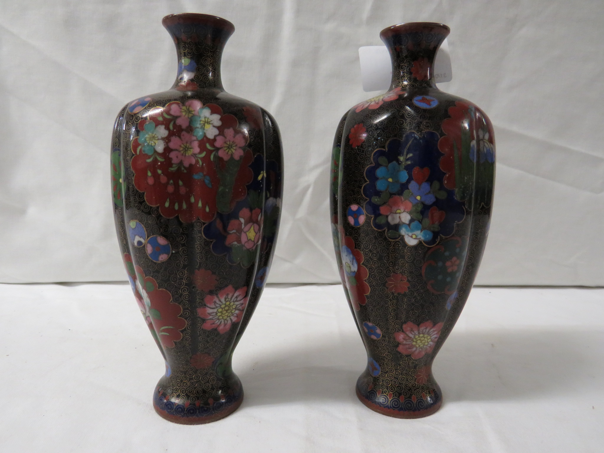 PAIR OF SMALL BLACK GROUND RIBBED CLOISONNE ENAMELLED VASES PATTERNED WITH VARIOUS FLOWERS AND - Image 2 of 5