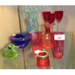 THREE RUBY GLASS WINE GLASSES AND ASSORTED COLOURED GLASSWARE INCLUDING VASES AND BOWLS
