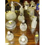 SELECTION OF CUT GLASS DRESSING TABLE JARS AND SCENT BOTTLES, SOME WITH SILVER COLLARS AND LIDS (A/