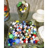 LARGE QUANTITY OF GLASS MARBLES (CONTENTS OF GLASS TRAY AND GLASS VASE)