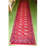 RED GROUND PATTERNED LONG FLOOR RUNNER WITH FIVE MARGINS (A/F)