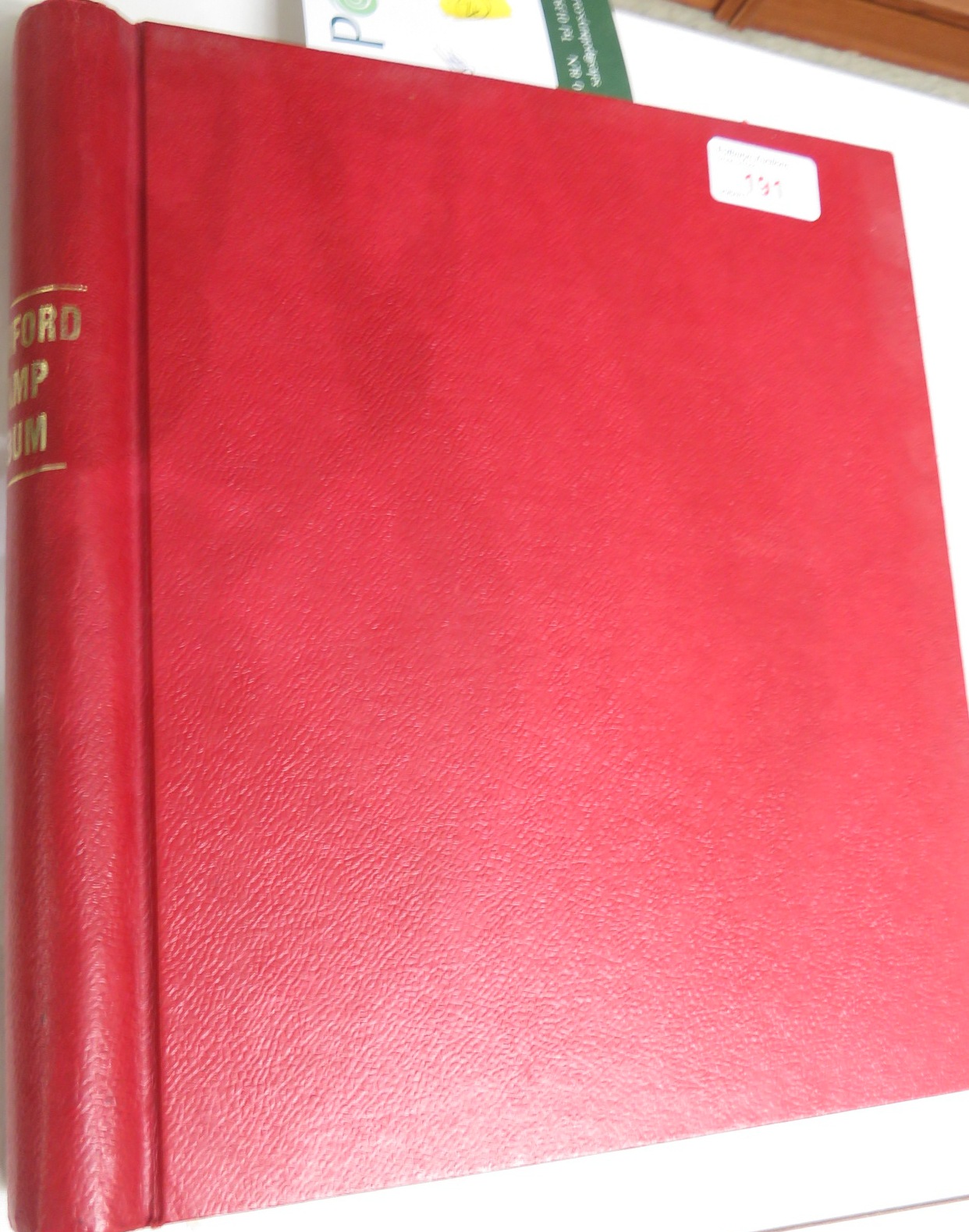 A red Stamford stamp album including seven Victorian one penny reds, two Victorian penny blues and