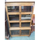 Oak sectional bookcase of four sections, each tier with glazed doors hinged to the sides, no