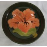 A small Moorcroft pottery hibiscus bowl, green ground with pink flower, height 4cm, diameter 11cm,