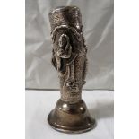 Indian white metal pepper engraved with foliage and modelled with three figures, screw-in base,