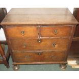 An early oak chest of two short over two long graduated drawers with brass escutcheons and pendant