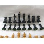 A set of light wood and ebonised wood chess pieces, the bases fixed with a dowel for play on a