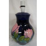 Moorcroft pottery magnolia table lamp, baluster shape, dark blue ground, pink flowers, the base