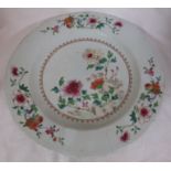 A Chinese porcelain famille rose dish painted with flowering plants, the border with three