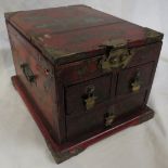 A 20th century Chinese or Japanese style jewellery box in decorative red lacquer, three drawers with