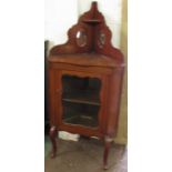 Edwardian red walnut corner cabinet with a single front door enclosing a shelf, reeded and canted