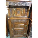 Narrow oak court cupboard, the upper section with a small square door on brass H hinges, the