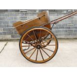 A late 19th century governess cart with refurbished seats, overall length about 323cm, diameter of