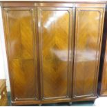 A large Edwardian mahogany and burr walnut veneer triple wardrobe with applied gilt mouldings in the