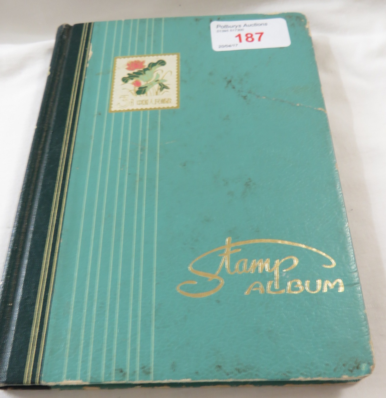 A green pocket album of Victorian and other stamps