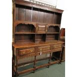 Early 19th century carved oak dresser with three long drawers, baluster legs and open pot shelf. The