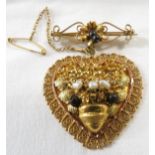 Yellow metal heart-shaped pendant brooch suspended from scrolled bar, moulded with foliage and