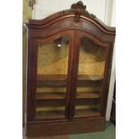 A grandly proportioned early nineteenth century mahogany china display cabinet with arched top,