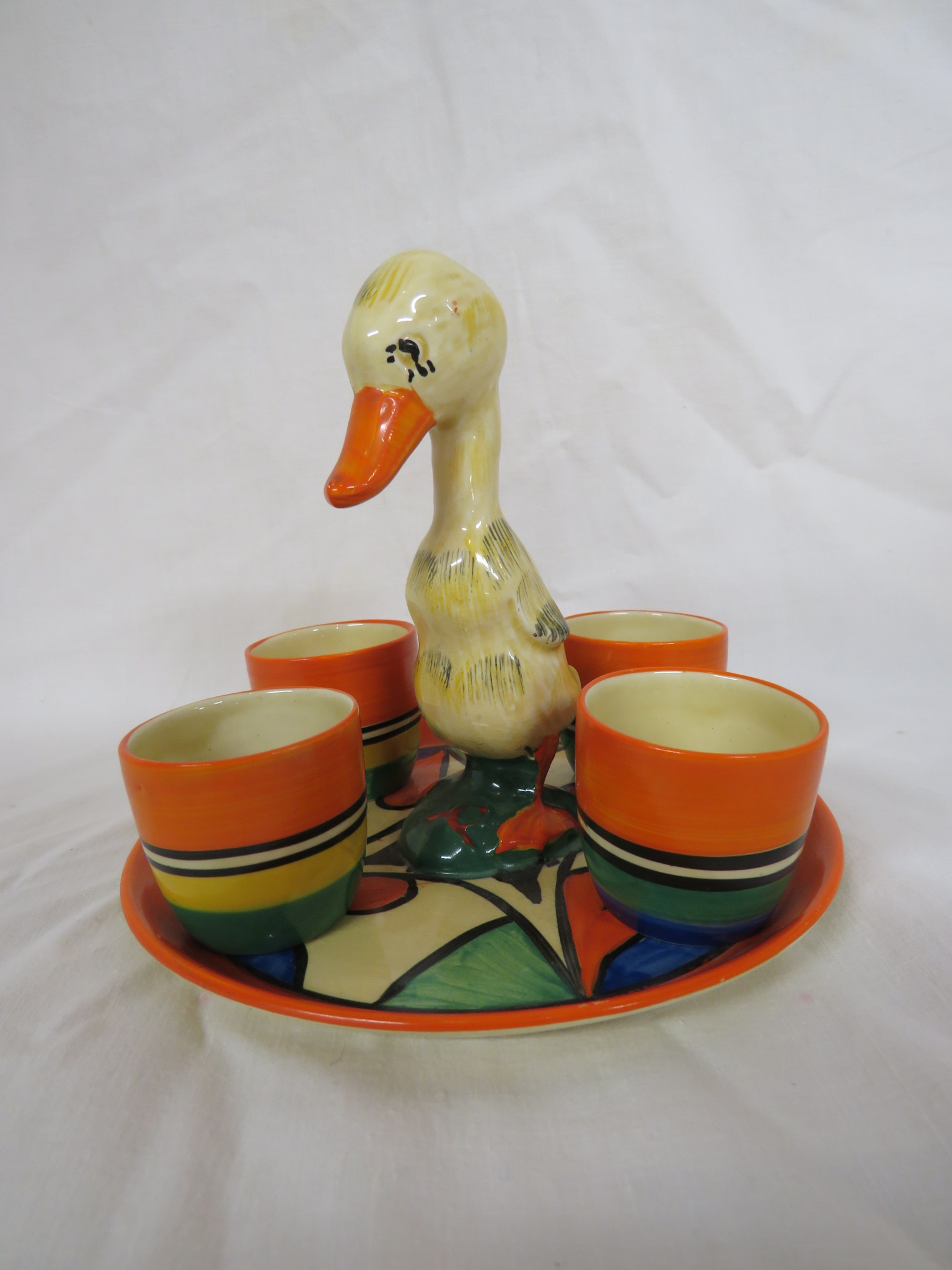 A Clarice Cliff Bizarre duck egg cruet, the stand with an orange border and stylized leaf pattern in - Image 2 of 5