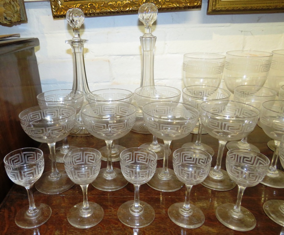 A suite of drinking glasses and a near pair of bottle shape decanters, all etched with key fret - Image 2 of 8