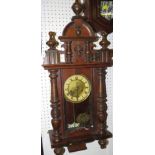 A Victorian eight day chiming wall clock in a stained walnut and beech case with two turned