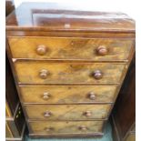 An early nineteenth century mahogany tall and narrow chest of five graduated drawers with brass