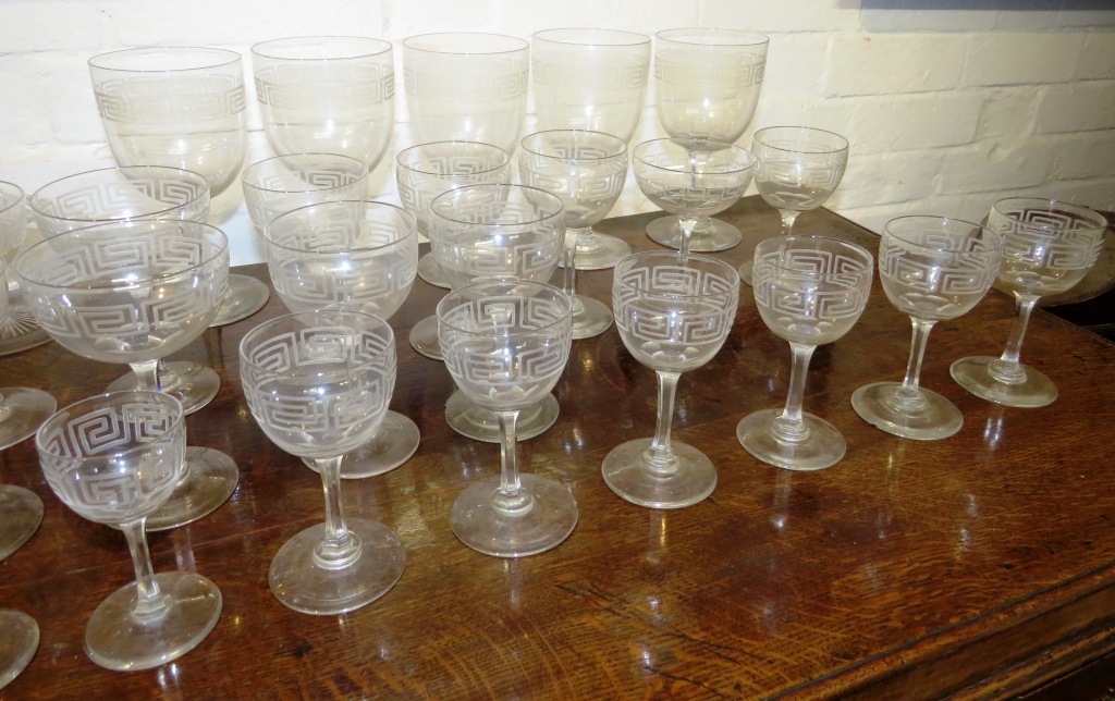 A suite of drinking glasses and a near pair of bottle shape decanters, all etched with key fret - Image 3 of 8