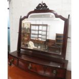 A Victorian mahogany bow fronted toilet swing mirror with three drawers below on bun feet, pierced